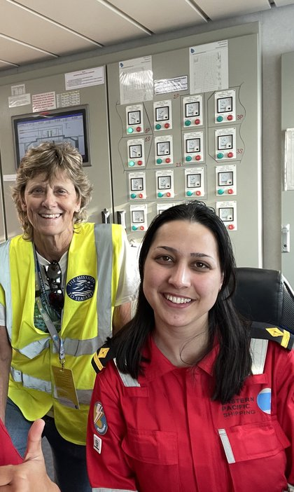 A volunteer and crew member in a ship control room