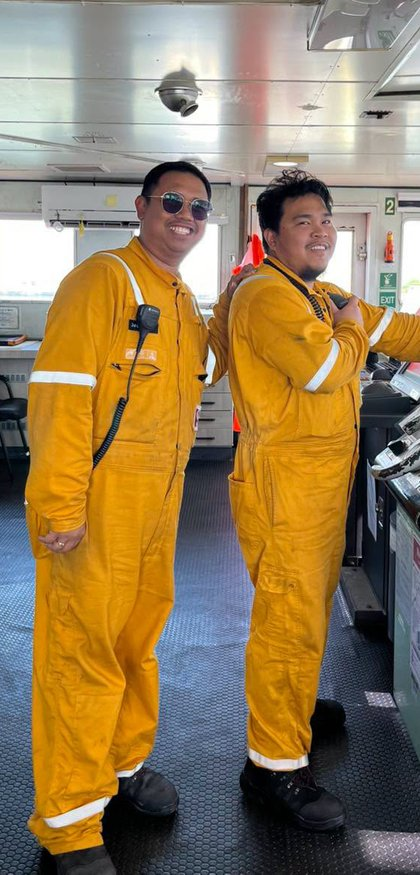 Two crew members posing on the bridge