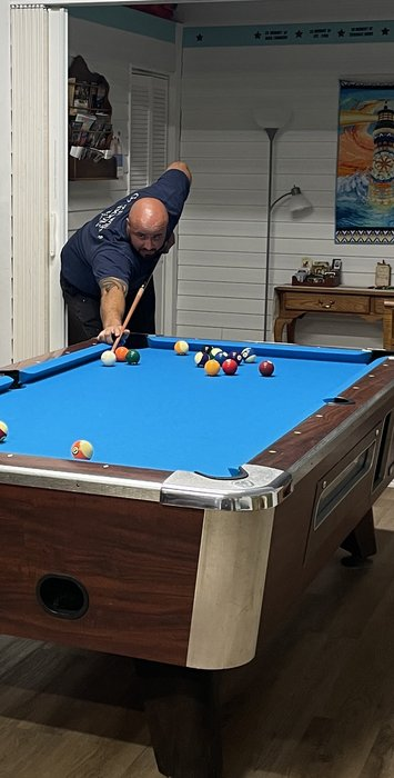 Crew members playing pool at the center