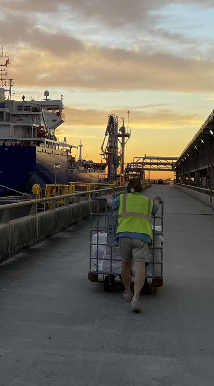 A crew member posing on a ship gangway