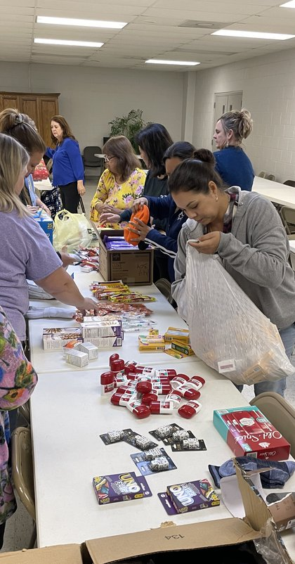 A group of volunteers packing gift boxes at the center