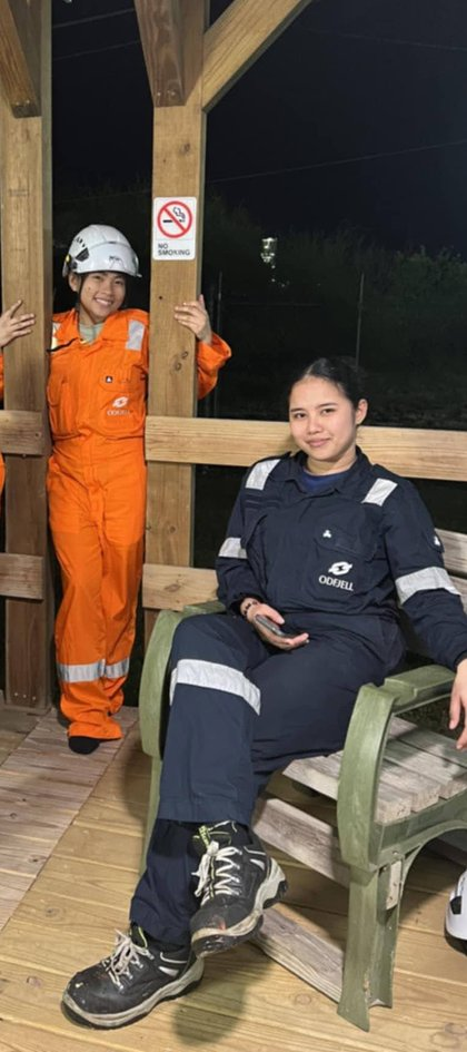 Two crew members posing together in the evening at the center